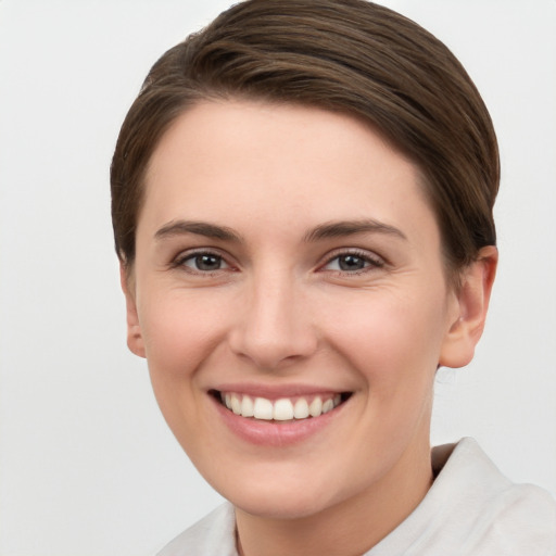 Joyful white young-adult female with short  brown hair and brown eyes