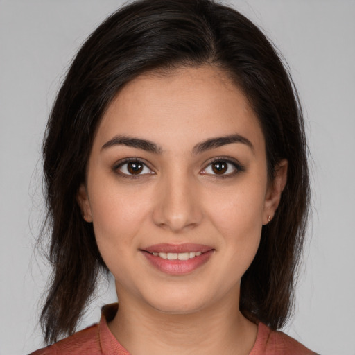 Joyful white young-adult female with medium  brown hair and brown eyes