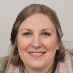 Joyful white adult female with medium  brown hair and grey eyes