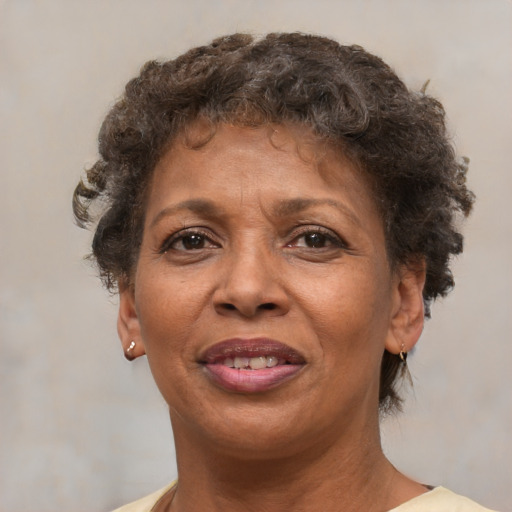 Joyful black adult female with short  brown hair and brown eyes