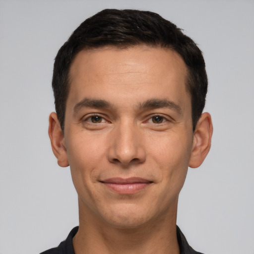 Joyful white young-adult male with short  black hair and brown eyes