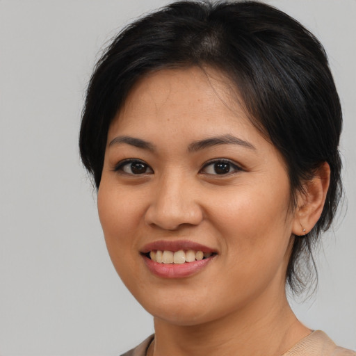 Joyful asian young-adult female with medium  brown hair and brown eyes