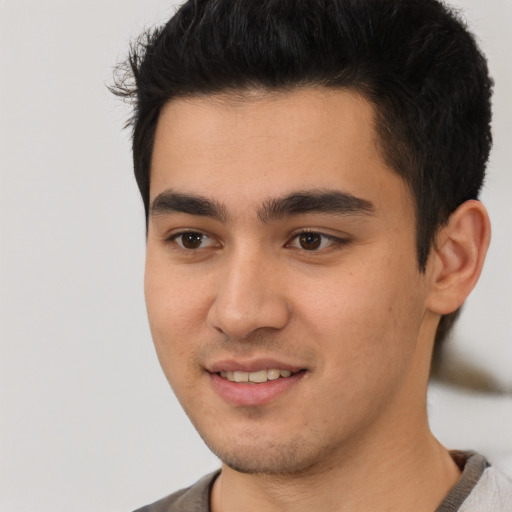 Joyful latino young-adult male with short  black hair and brown eyes
