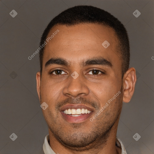 Joyful black young-adult male with short  brown hair and brown eyes