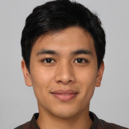 Joyful asian young-adult male with short  black hair and brown eyes