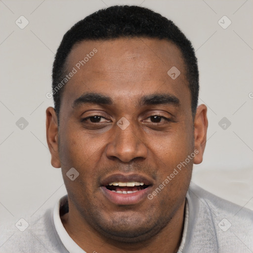 Joyful black young-adult male with short  black hair and brown eyes