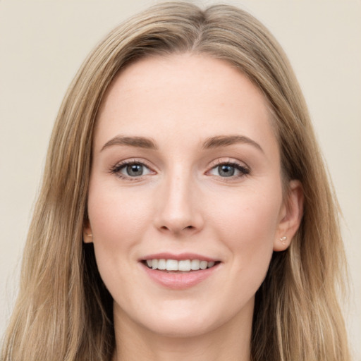 Joyful white young-adult female with long  brown hair and green eyes