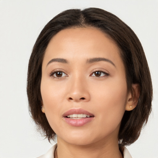 Joyful white young-adult female with medium  brown hair and brown eyes