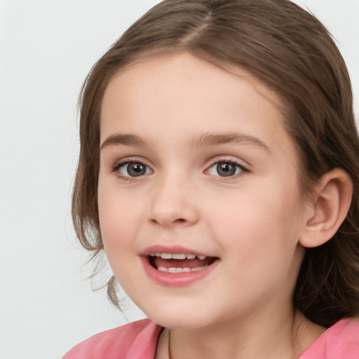 Joyful white child female with long  brown hair and brown eyes