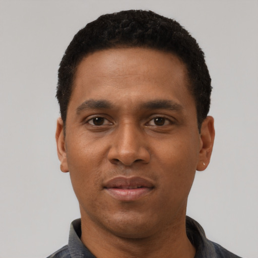 Joyful black adult male with short  black hair and brown eyes