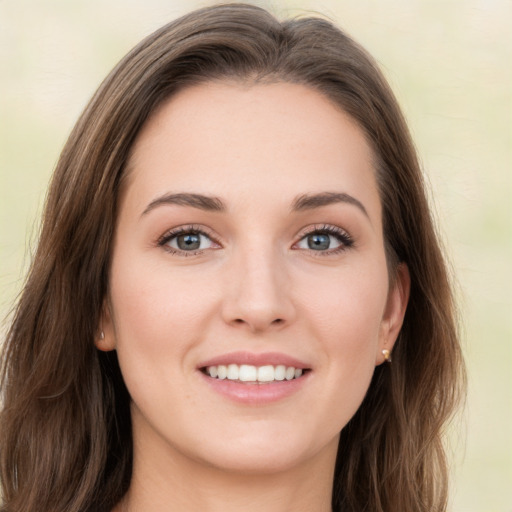 Joyful white young-adult female with long  brown hair and green eyes