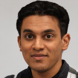 Joyful latino young-adult male with short  black hair and brown eyes