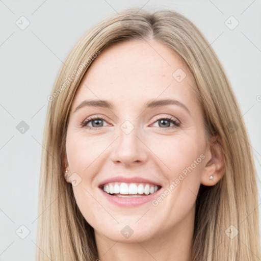 Joyful white young-adult female with long  brown hair and grey eyes