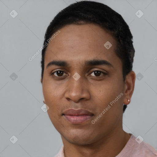 Joyful black young-adult male with short  black hair and brown eyes