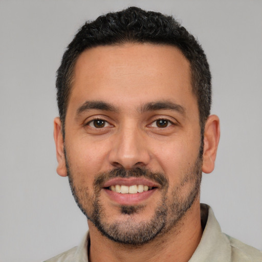 Joyful white young-adult male with short  black hair and brown eyes