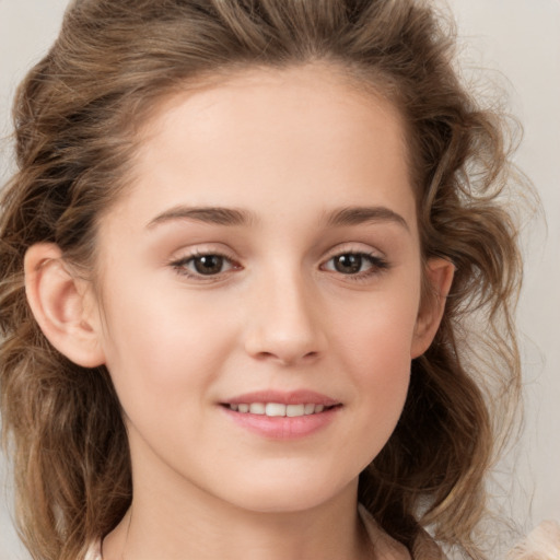 Joyful white child female with long  brown hair and brown eyes