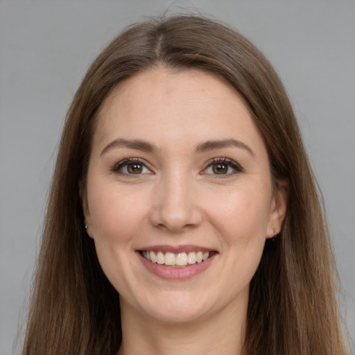 Joyful white young-adult female with long  brown hair and brown eyes