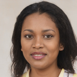 Joyful black young-adult female with long  brown hair and brown eyes