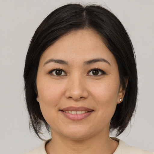 Joyful asian young-adult female with medium  brown hair and brown eyes
