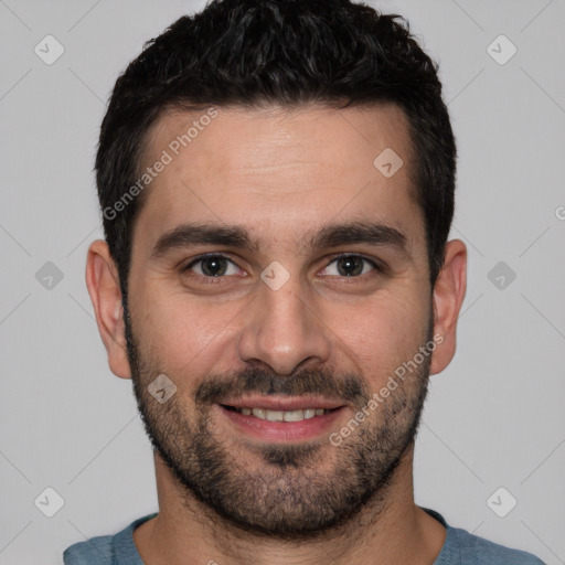 Joyful white young-adult male with short  black hair and brown eyes