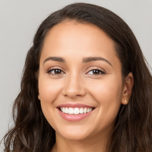 Joyful white young-adult female with long  brown hair and brown eyes