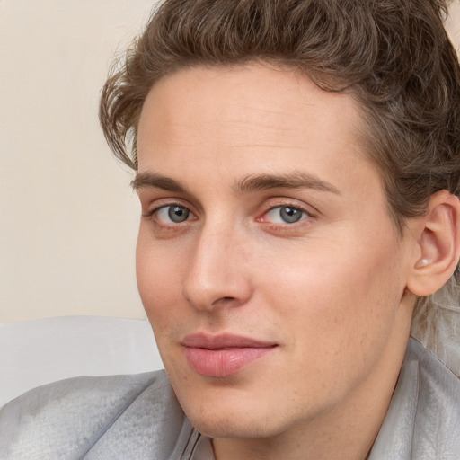 Joyful white young-adult male with short  brown hair and blue eyes