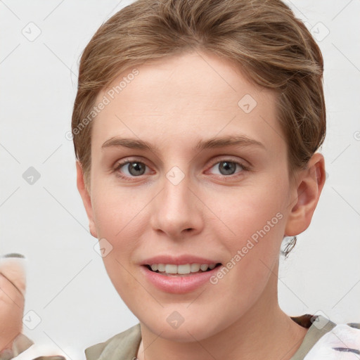 Joyful white young-adult female with short  brown hair and grey eyes