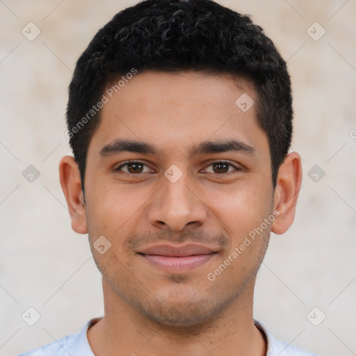 Joyful latino young-adult male with short  black hair and brown eyes