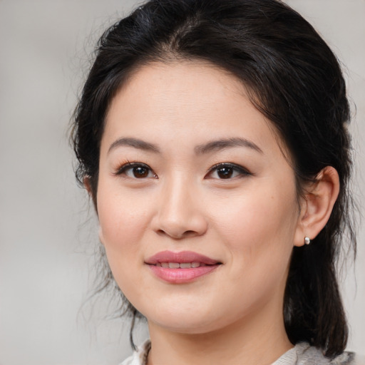 Joyful white young-adult female with medium  brown hair and brown eyes