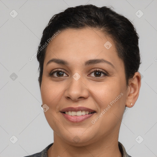 Joyful latino young-adult female with short  brown hair and brown eyes