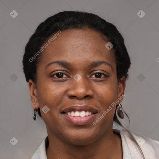Joyful black young-adult female with short  brown hair and brown eyes