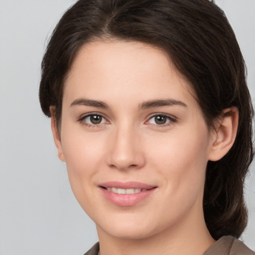 Joyful white young-adult female with medium  brown hair and brown eyes