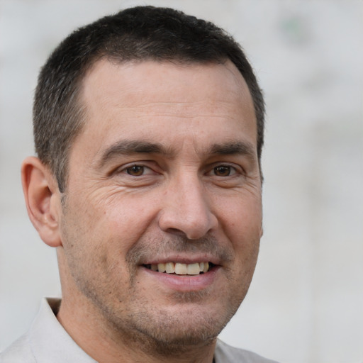 Joyful white adult male with short  brown hair and brown eyes