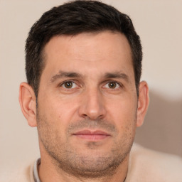 Joyful white adult male with short  brown hair and brown eyes