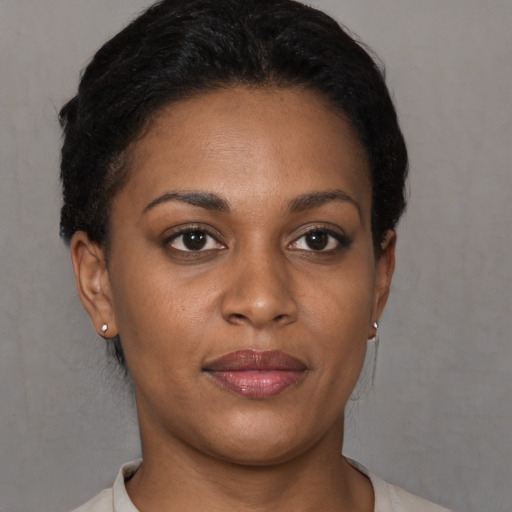 Joyful latino young-adult female with short  brown hair and brown eyes