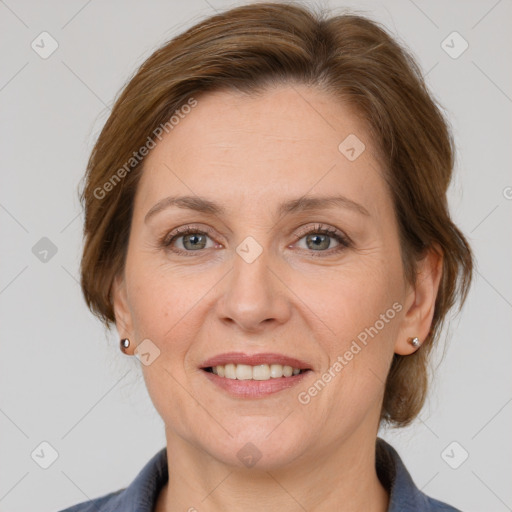 Joyful white adult female with medium  brown hair and grey eyes