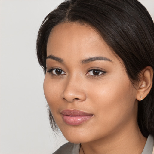 Neutral latino young-adult female with long  brown hair and brown eyes