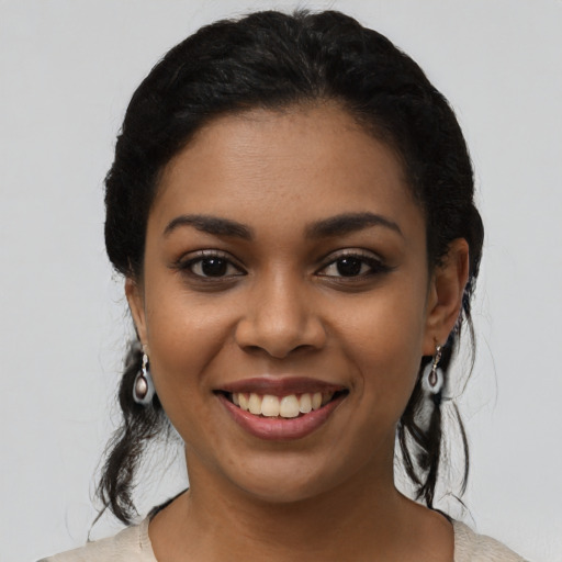 Joyful latino young-adult female with medium  black hair and brown eyes