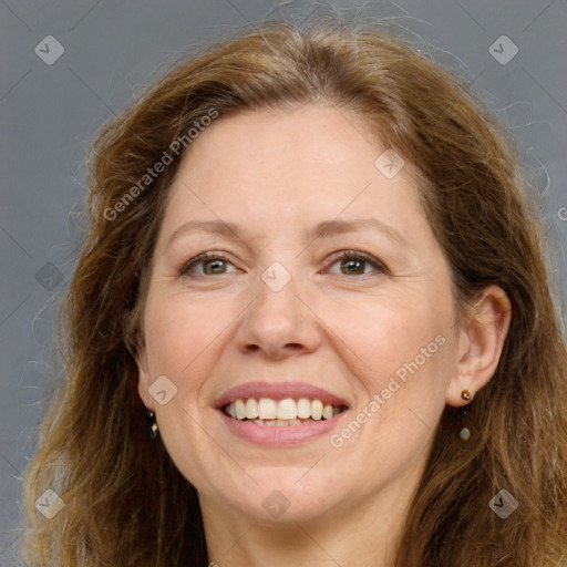 Joyful white adult female with long  brown hair and grey eyes