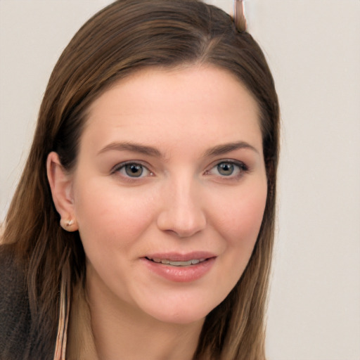 Joyful white young-adult female with long  brown hair and grey eyes