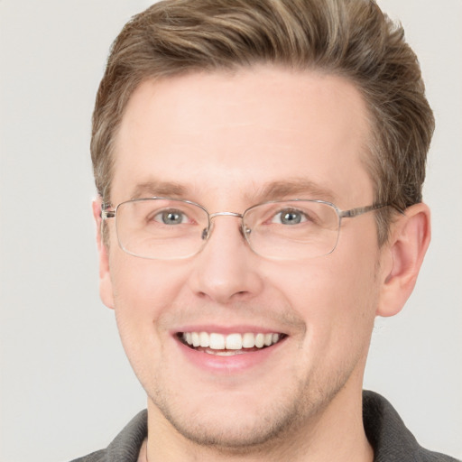 Joyful white adult male with short  brown hair and grey eyes