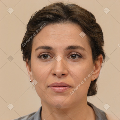 Joyful white adult female with short  brown hair and brown eyes