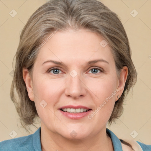 Joyful white adult female with medium  brown hair and blue eyes