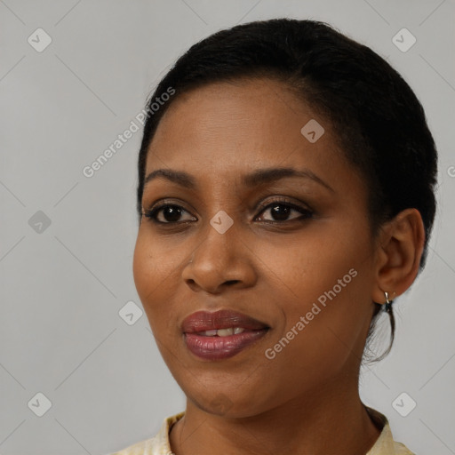 Joyful black young-adult female with short  black hair and brown eyes