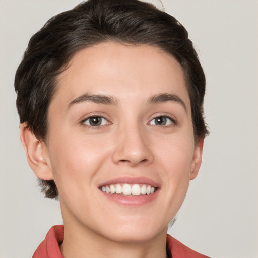 Joyful white young-adult female with short  brown hair and grey eyes