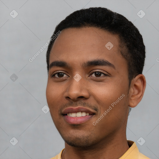 Joyful latino young-adult male with short  black hair and brown eyes