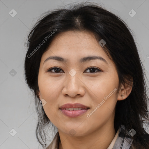 Joyful latino adult female with medium  brown hair and brown eyes