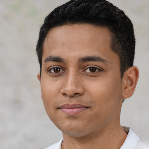 Joyful latino young-adult male with short  black hair and brown eyes