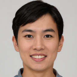 Joyful asian young-adult male with short  black hair and brown eyes