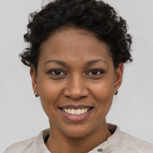 Joyful black young-adult female with short  brown hair and brown eyes